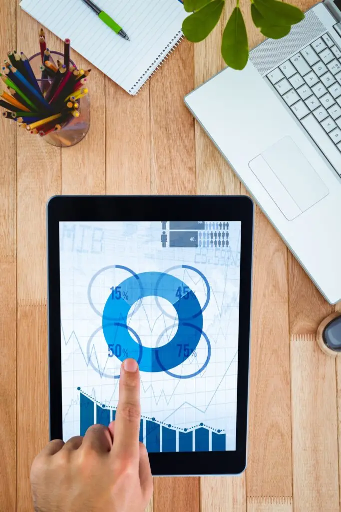 composite of hands using tablet computer with desk background